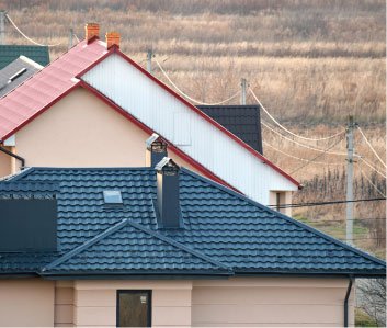 Houses with new red and dark grey tiled roofs
