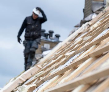 Roofer working on timber roof battens