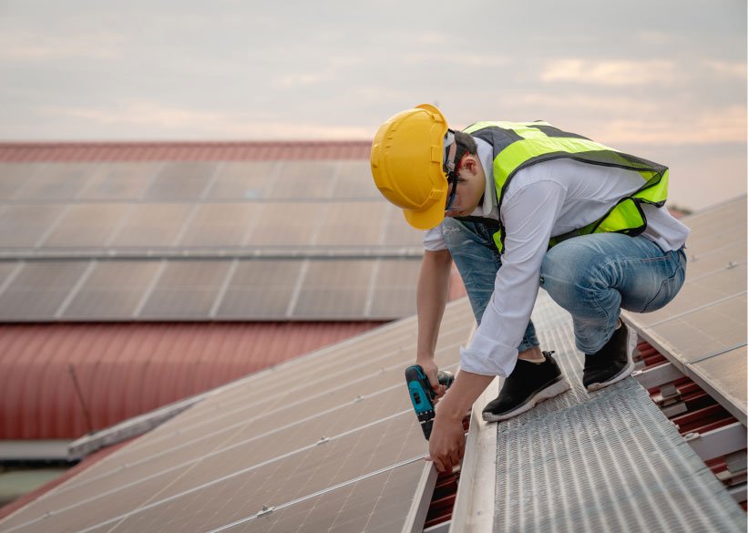 Roofer in a hard hat fixing a pitched roof in Bristol